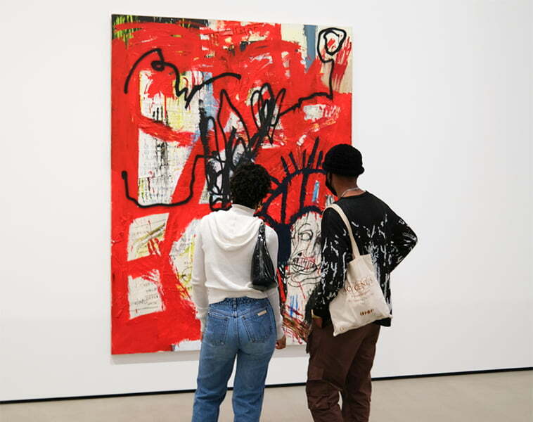 Friends looking at art in a modern gallery