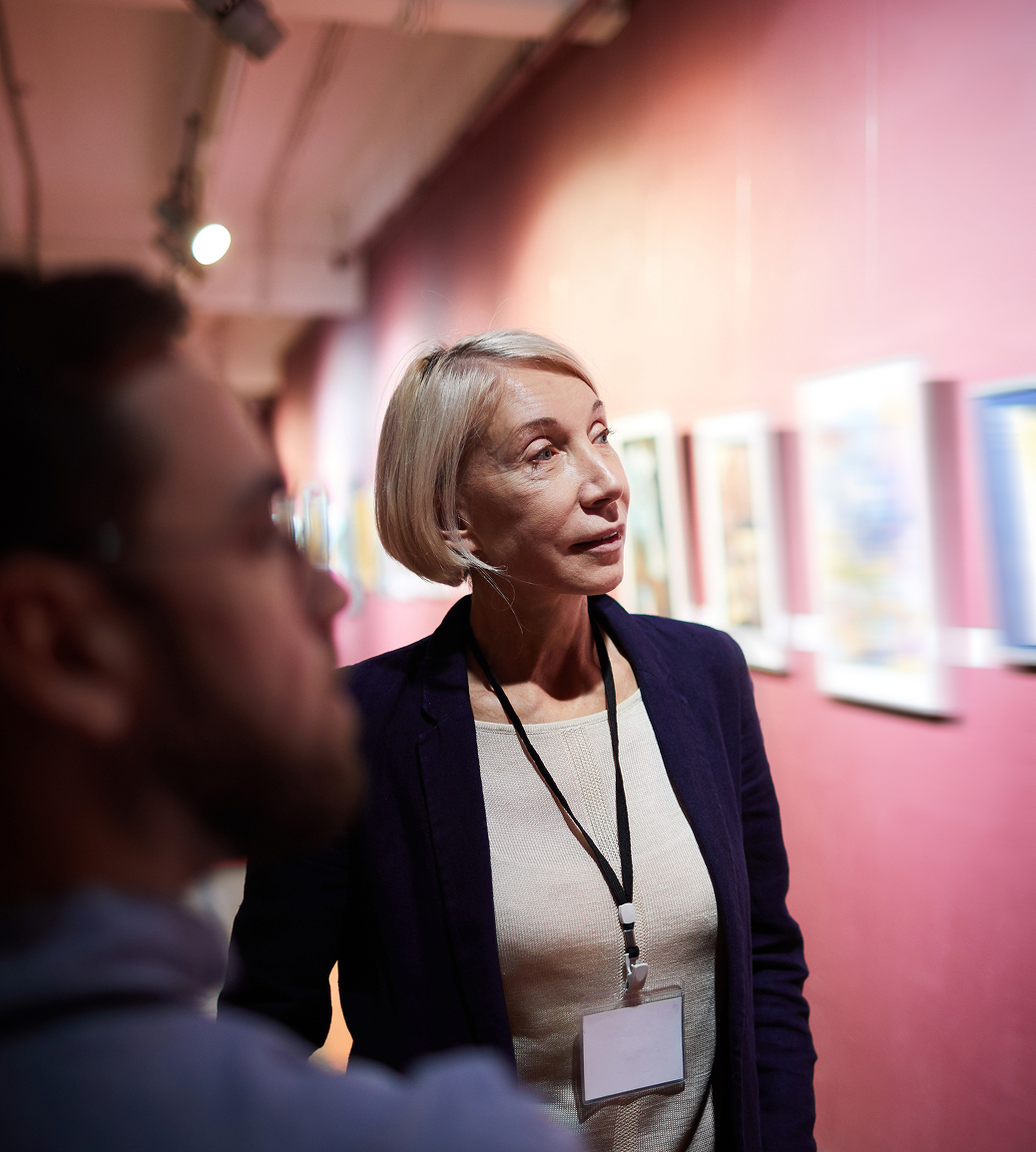 A museum manager provides guidance to her staff on an art installation