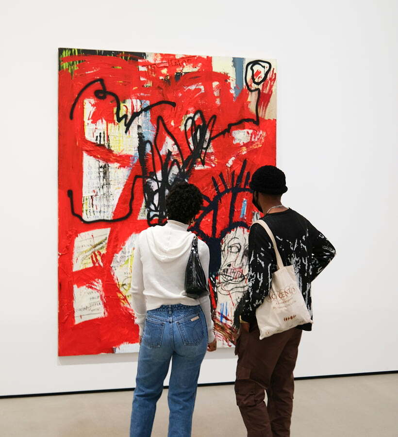 Friends looking at art in a modern gallery