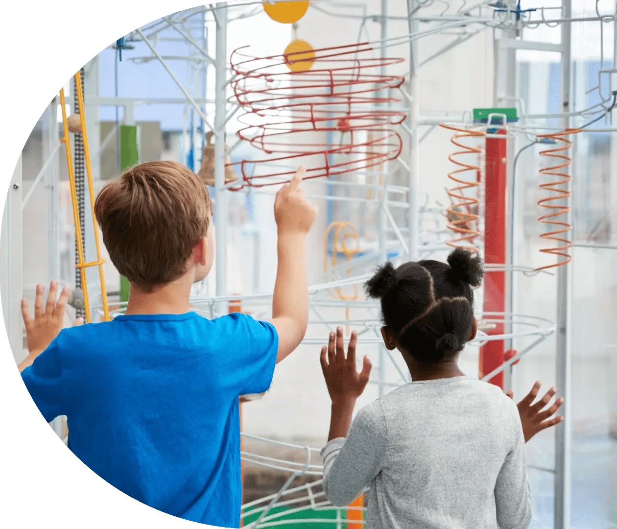 Young school group play with exhibition in a science center