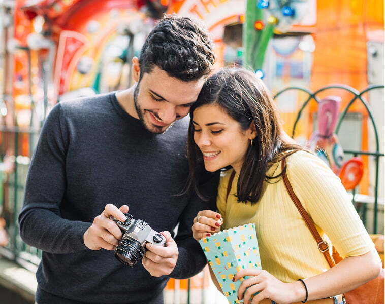 Couple take photos during a day out at a Visitor Attraction 